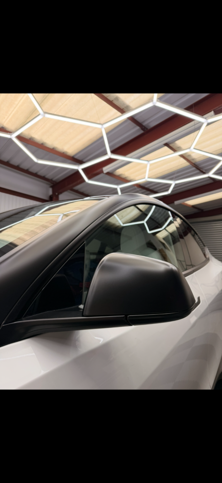 gloss black tuxedo vinyl wrap installed on white Tesla in Winterbourne 