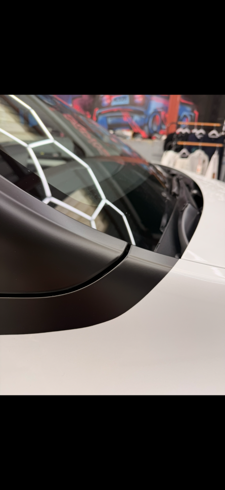 gloss black tuxedo vinyl wrap installed on white Tesla in Winterbourne 