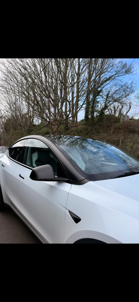 gloss black tuxedo vinyl wrap installed on white Tesla in Winterbourne 