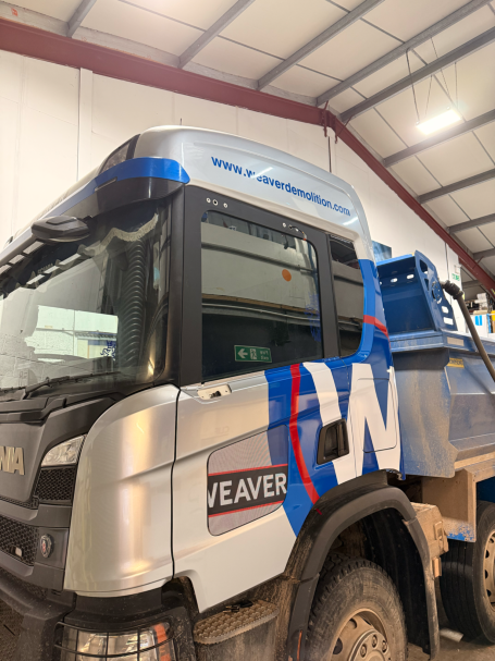 full lorry cab wrap in gloss silver with some blue and red graphics on top for avonmouth signs 